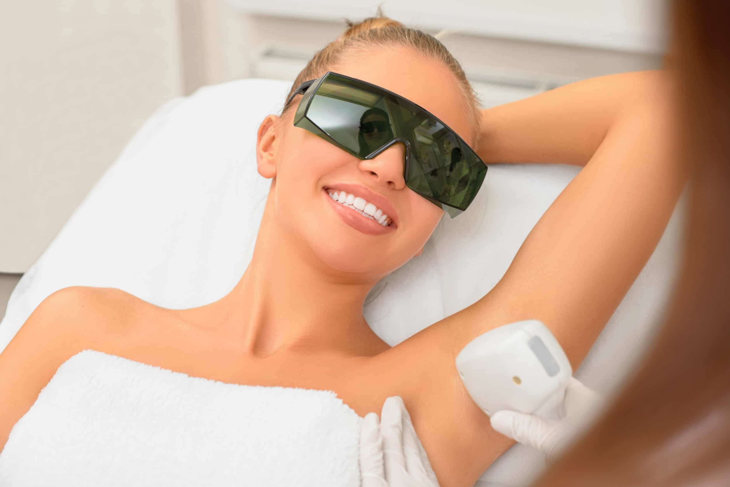 A woman getting laser hair removal in her armpits